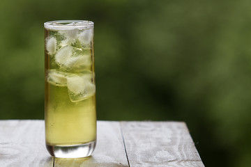 Green tea with ice in a tall glass