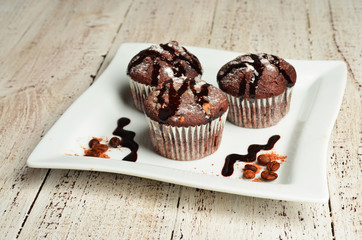 Cupcake with chocolate on wooden background