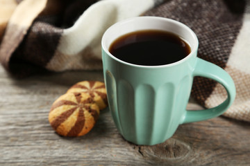 Cup of coffee with cookies on grey wooden background