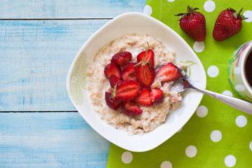 Milk oatmeal porridge with strawberries