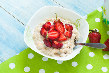 Milk oatmeal porridge with strawberries