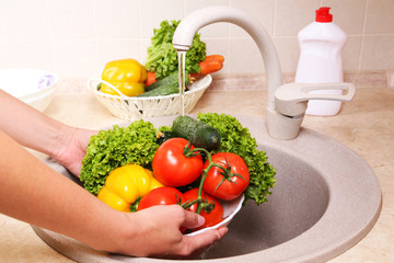 Vegetables washing in kitchen