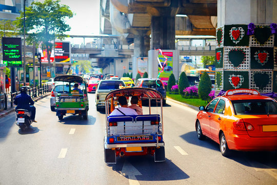 traditional vehicles moving on the main road in Bangkok