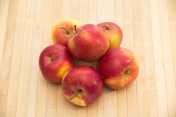 Red apples on support colour of a tree