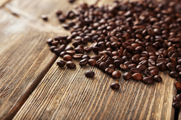 Coffee beans on brown wooden background