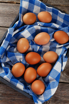 Chicken eggs in tray on grey wooden background