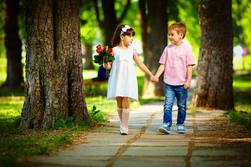 cute kid walking together in summer park