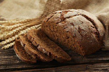 Freshly baked bread on brown wooden background