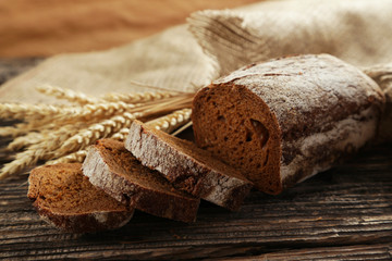 Freshly baked bread on brown wooden background