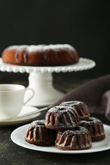 Chocolate bundt cakes on plate on black background