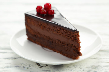 Dark chocolate cake on white wooden background