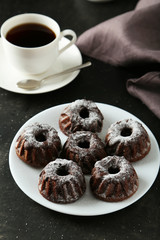 Chocolate bundt cakes on plate on black background