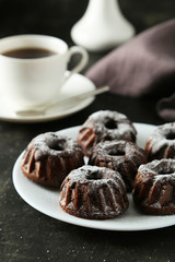 Chocolate bundt cakes on plate on black background