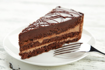 Dark chocolate cake on white wooden background