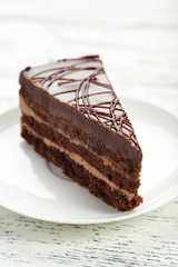 Dark chocolate cake on white wooden background
