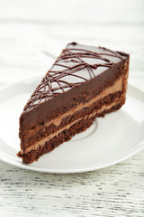 Dark chocolate cake on white wooden background