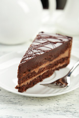 Dark chocolate cake on white wooden background