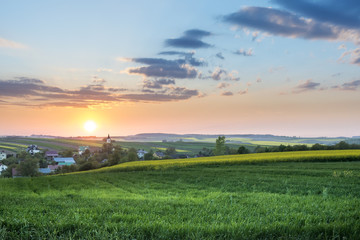 Naklejka na ściany i meble Sundown over village on Polish countryside