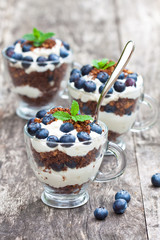 homemade desert with cream chopped cookies and fresh blueberry