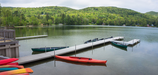 pier on lake with kayaks and canoes