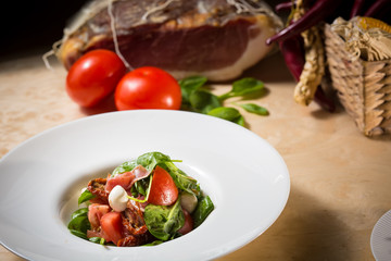 Salad with strawberry, prosciutto, herbs, cottage cheese and