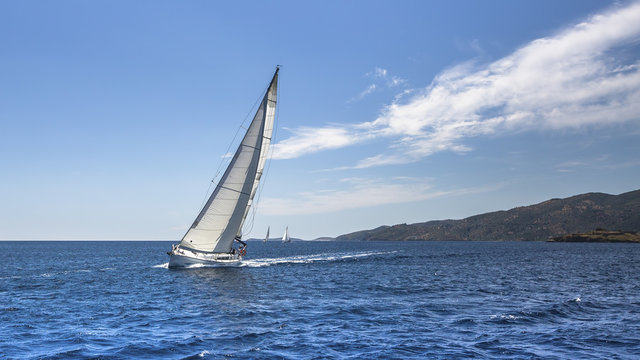 Sailing. Yacht sails with beautiful cloudless sky.