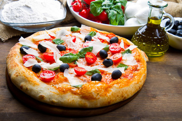 pizza with mozzarella,olives and tomatoes