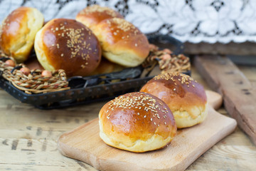 buns for burgers on wooden background