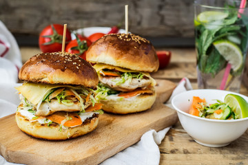 burgers with chicken and stuffed  juicy with cucumber, carrots a