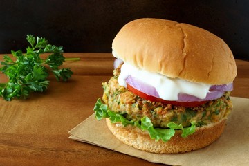 Falafel burger with lettuce, tomato, red onion and tzatziki