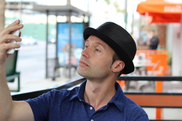 Urban man skyping in a cafe 