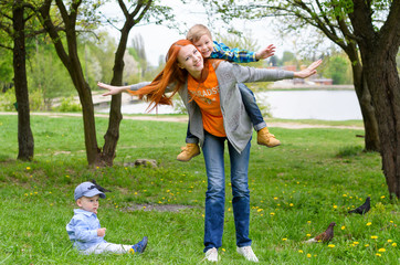 Fototapeta premium a mother plays the nature with babies