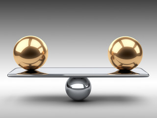 Balance between two large gold spheres.