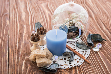 spa stuff on wooden background: candle, aroma