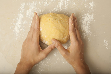 a female hand rolling threshing flour making pasta homemade