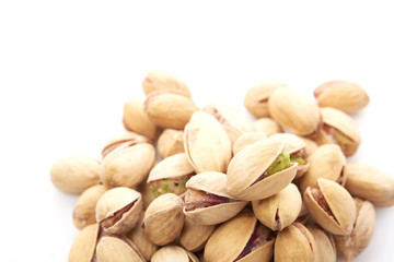Heap of pistachios nuts isolated on the white