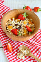 Cereal with fruit in a wooden bowl