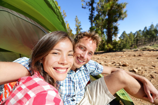 Selfie camping couple in tent taking self portrait