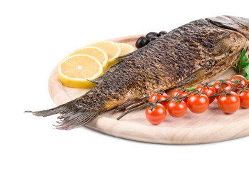 Fried carp on wooden platter.