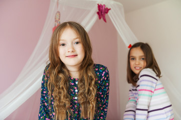 Two little girls playing in their room