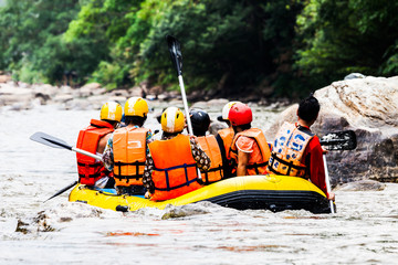 A group of men and women are rafting on the river, extreme and f
