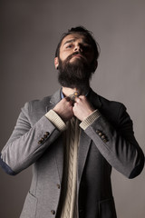 a young man with a long beard adjusts his frock