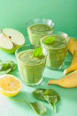 healthy green smoothie with spinach leaves apple lemon banana
