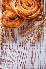 Wicker basket with raisin bakery goods wheat ears on vintage woo