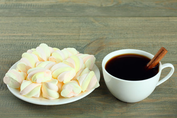 A cup of hot chocolate with marshmallows on the wooden background