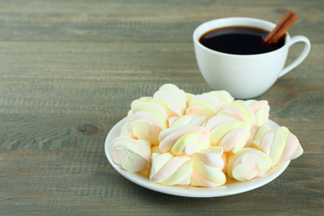 A cup of hot chocolate with marshmallows on the wooden background