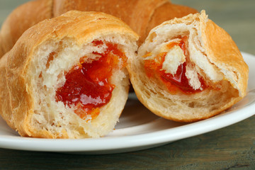 Croissants in a plate on a wooden background