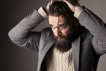 portrait of a sad young man with a beard and mustache
