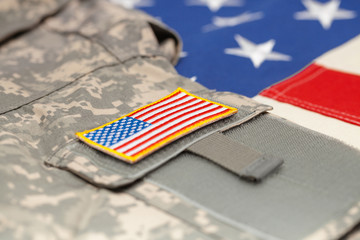USA flag with army uniform over it - studio shot