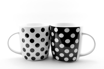 Black and white polka dots mugs isolated on white background